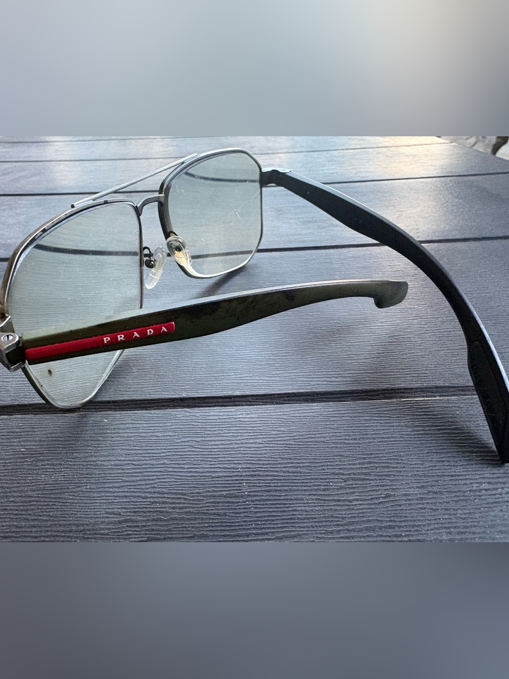 Prada Silver Metal Frame Glasses with Black Temples and Red Logo